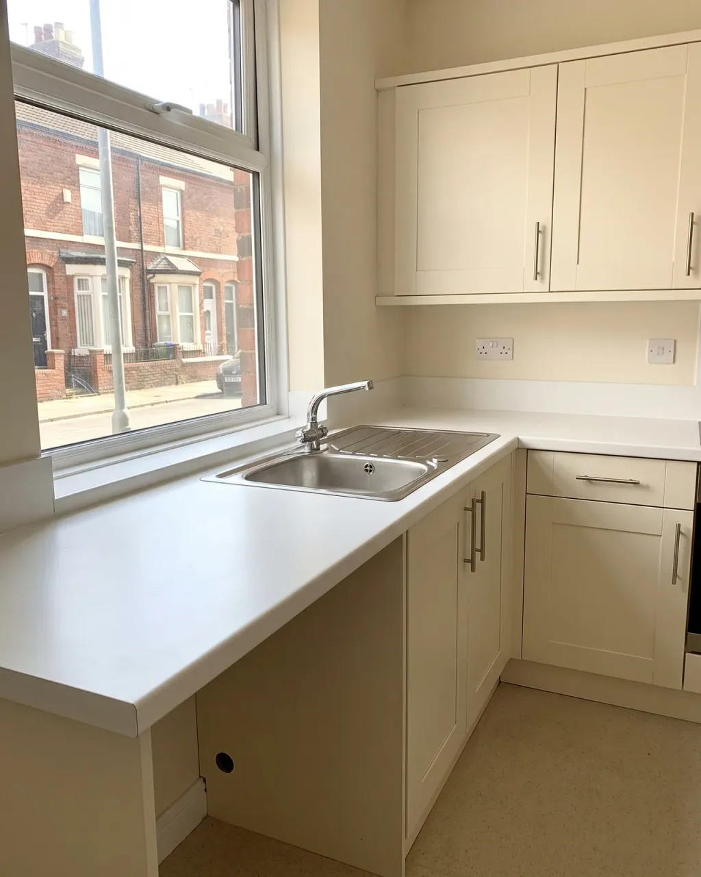 Tenant cleaning a kitchen worktop before a Liverpool checkout inspection